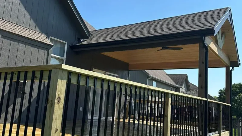 covered wooden deck with railing attached to a residential home in kansas city