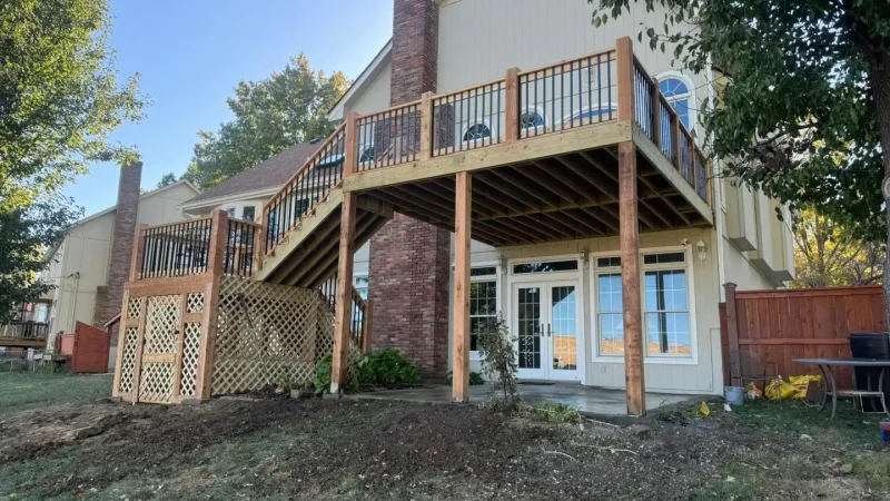 two-story wooden deck with lattice skirting attached to a home in kansas city