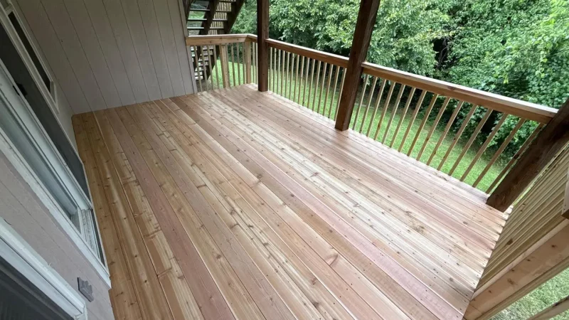 newly constructed wooden deck attached to a residential home overlooking a lush backyard in kansas city