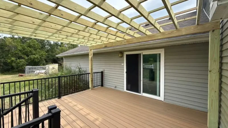 pergola-covered deck with composite flooring attached to a suburban home in the kansas city metro